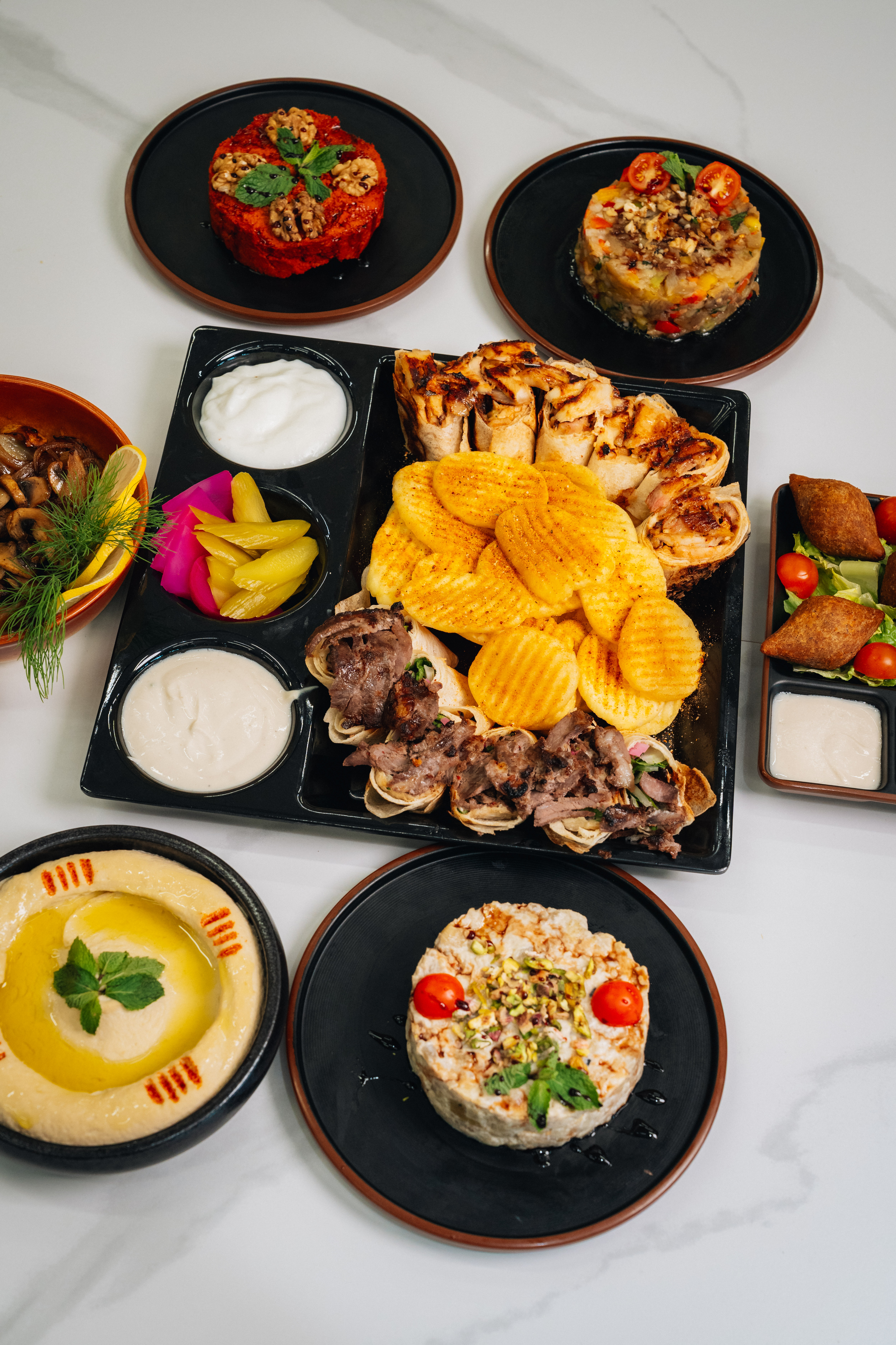 Sarde mixed platter with charcoal-grilled meats, hummus and fries