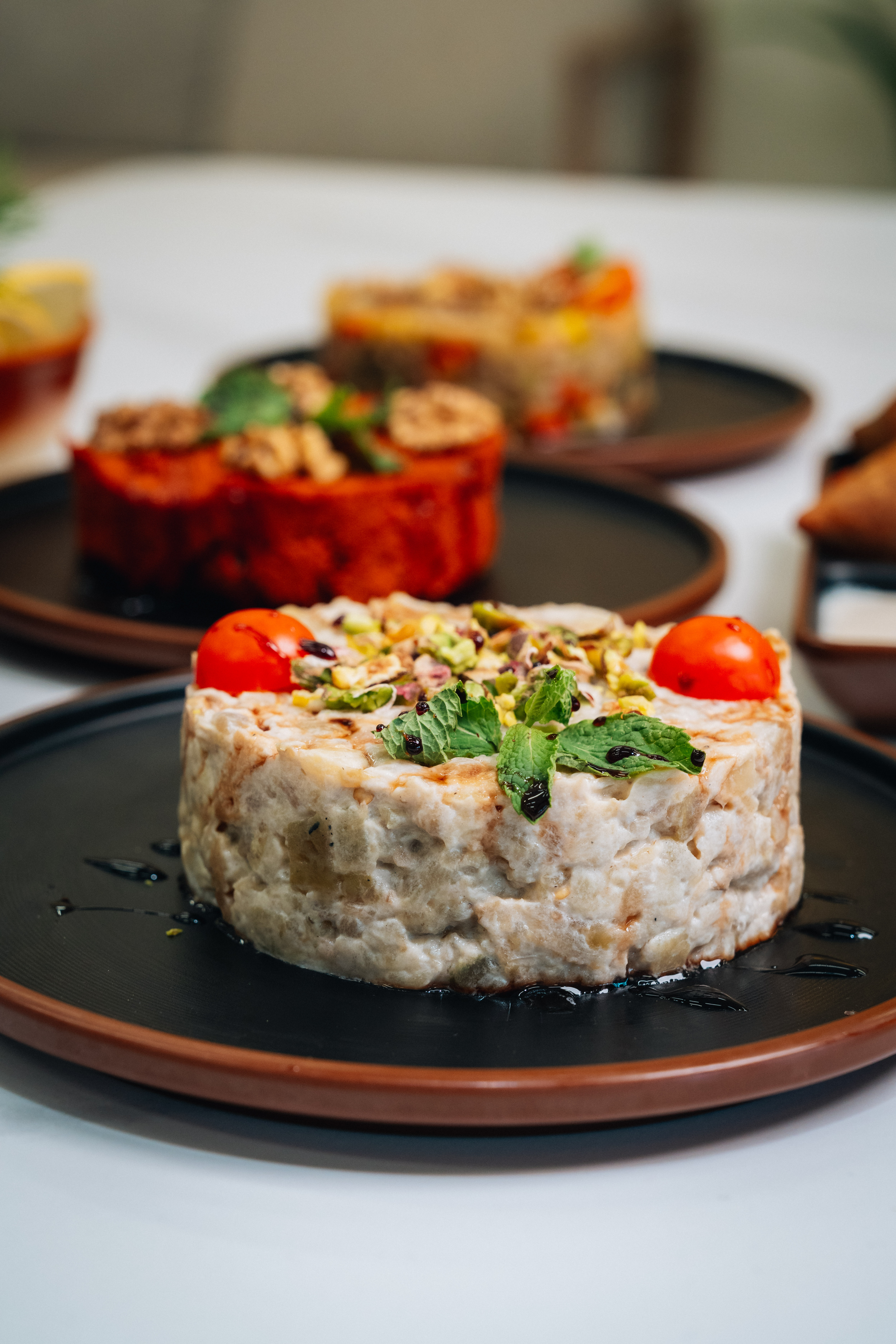 House kibbeh crowned with pistachio, mint and cherry tomato