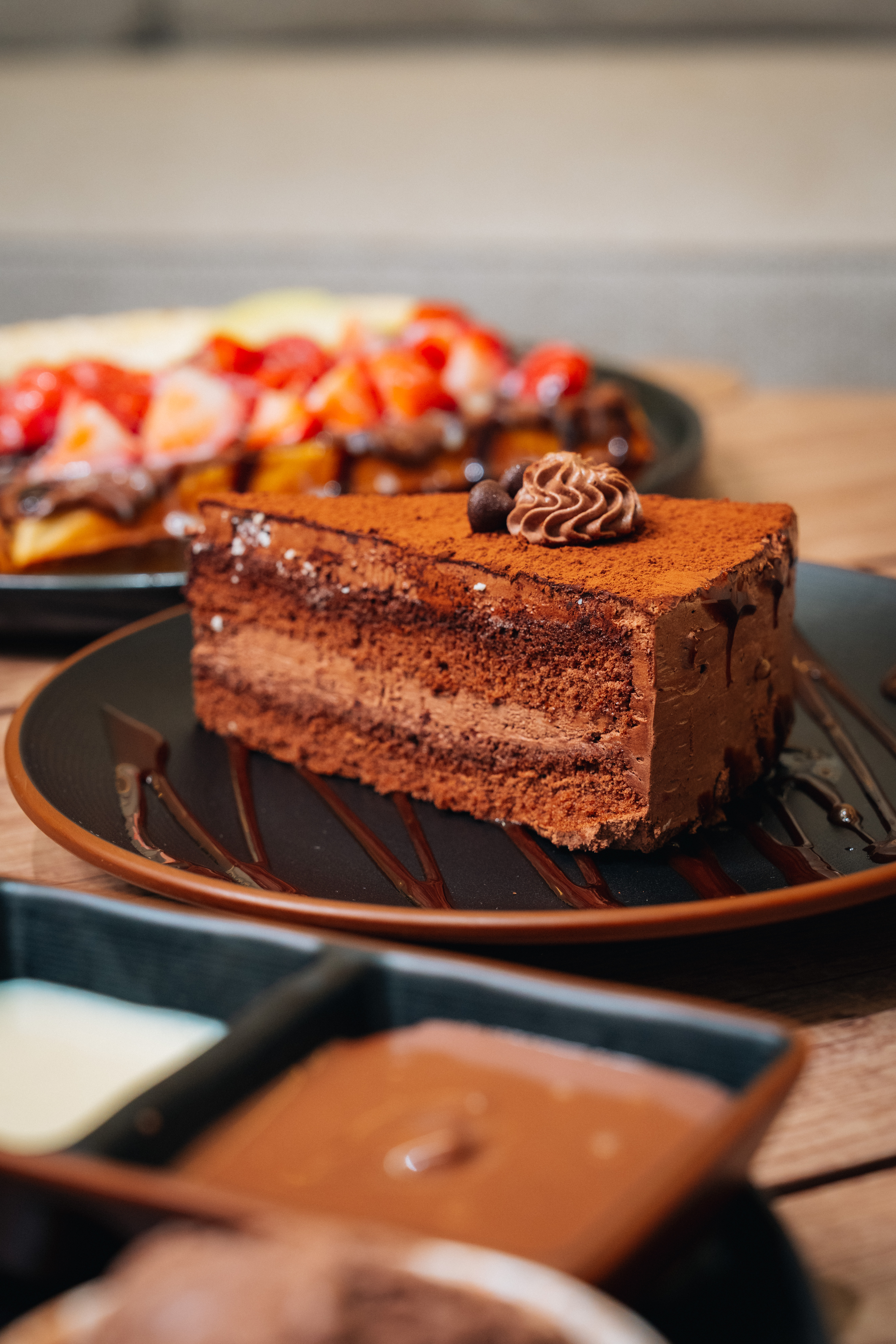Layered chocolate mousse cake dusted with cocoa